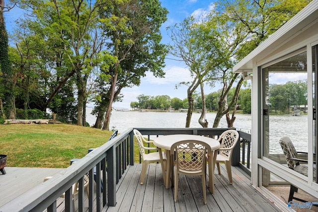 deck with a lawn and a water view