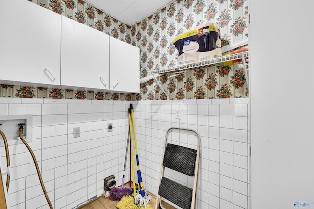 bathroom with tile walls, wallpapered walls, and heating unit