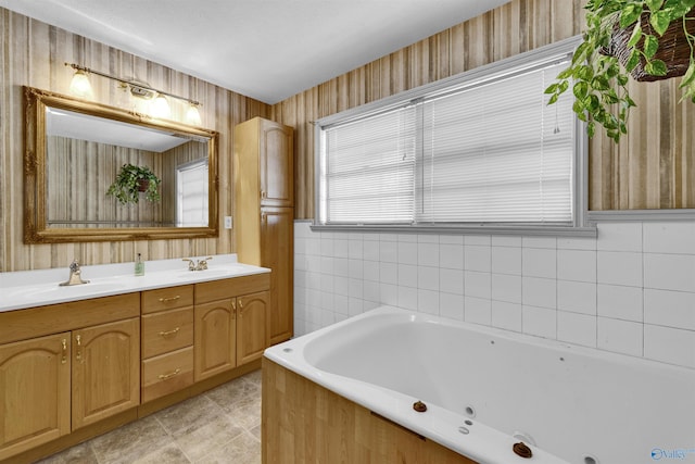 full bath featuring tile patterned flooring, a sink, double vanity, and a jetted tub