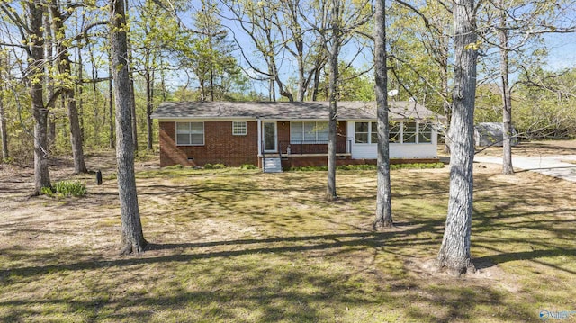 ranch-style house with crawl space, brick siding, and a front yard