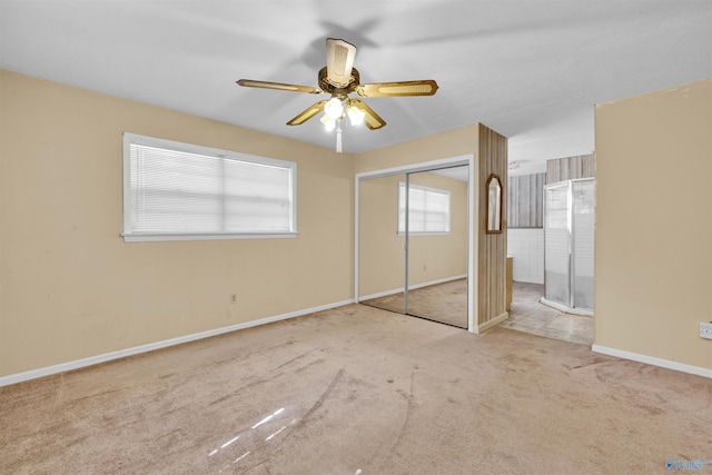 unfurnished bedroom featuring ceiling fan, carpet floors, a closet, and baseboards