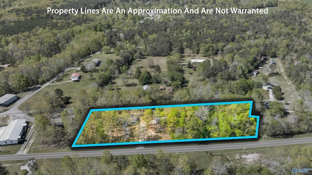 birds eye view of property featuring a forest view