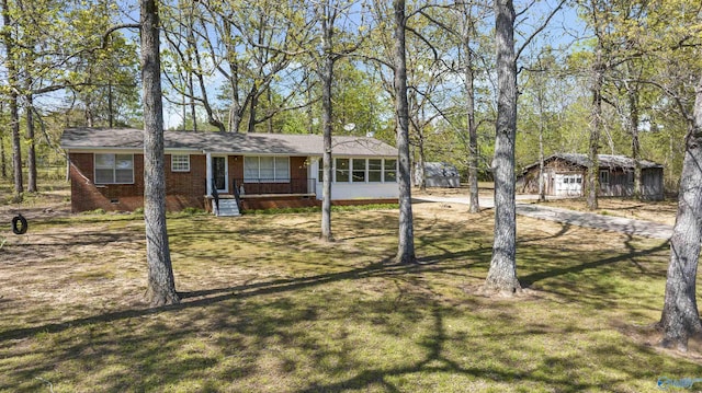 single story home featuring crawl space, a front lawn, driveway, and brick siding