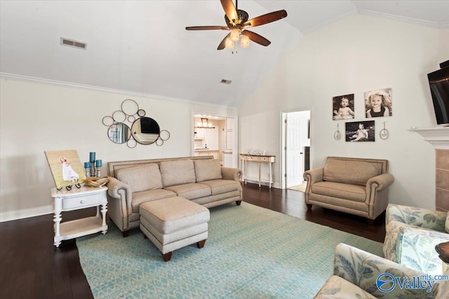 living room with high vaulted ceiling, crown molding, ceiling fan, wood-type flooring, and a tiled fireplace