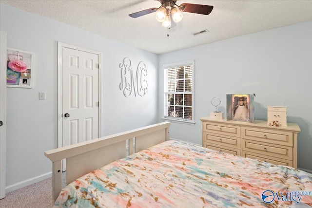 bedroom with light carpet, a textured ceiling, and ceiling fan