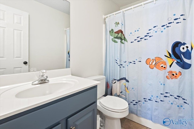 bathroom featuring tile patterned floors, vanity, toilet, and a shower with curtain