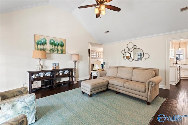 living room with ceiling fan, crown molding, dark hardwood / wood-style floors, and vaulted ceiling