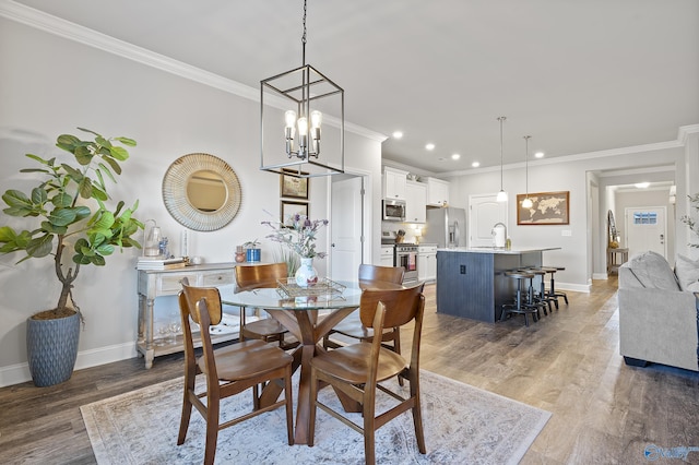 dining area featuring wood-type flooring, ornamental molding, and a chandelier