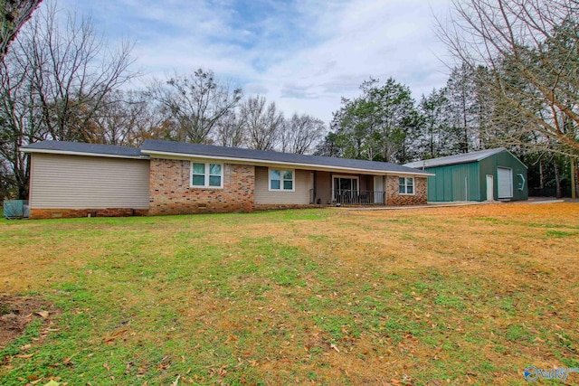 view of front facade featuring an outbuilding, a front lawn, and a garage