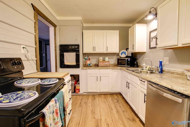 kitchen featuring ornamental molding, sink, black appliances, light hardwood / wood-style flooring, and white cabinets