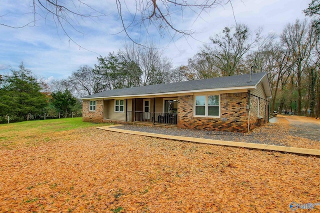 single story home with a front lawn and a porch