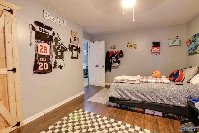 bedroom with ceiling fan and dark hardwood / wood-style floors