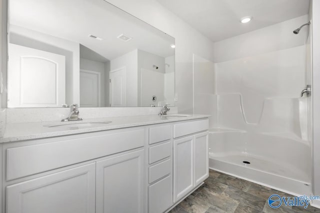 bathroom with vanity and walk in shower