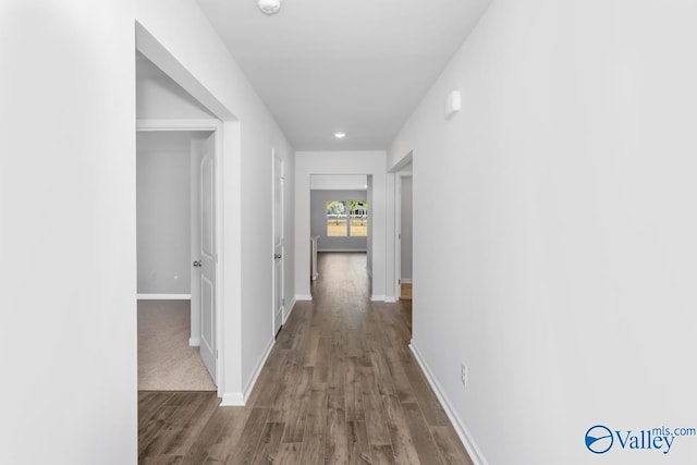 corridor with hardwood / wood-style flooring