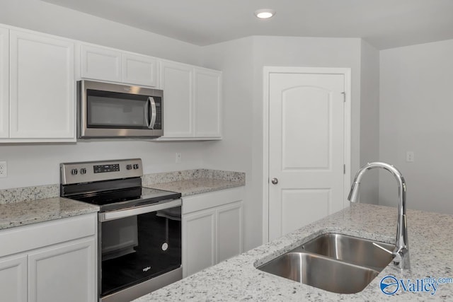 kitchen featuring appliances with stainless steel finishes, sink, and white cabinets