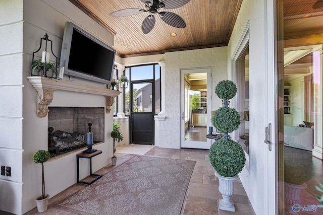 view of patio with ceiling fan and an outdoor fireplace