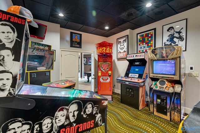 recreation room with a drop ceiling and carpet floors