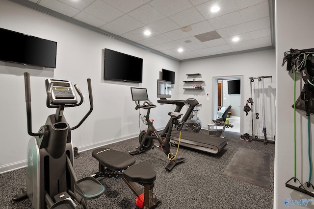 workout area featuring ornamental molding and a drop ceiling