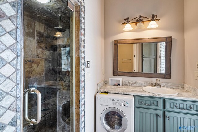 bathroom featuring washer / clothes dryer, vanity, and walk in shower