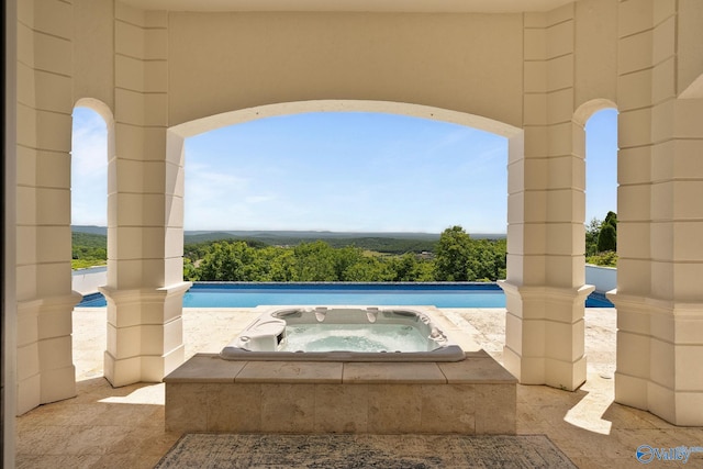 view of swimming pool with an in ground hot tub