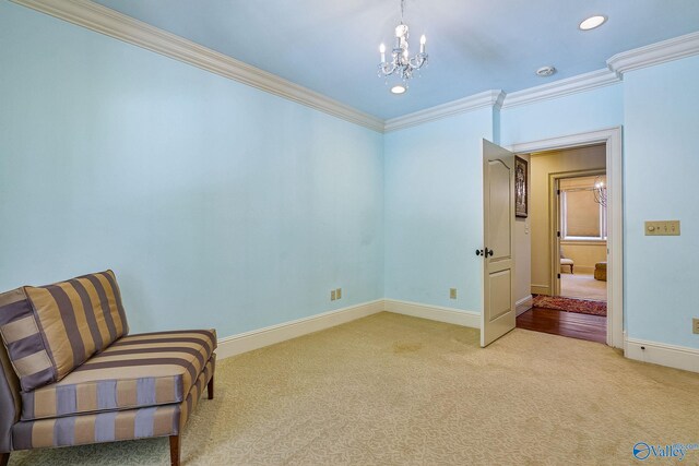 living area with carpet flooring, a notable chandelier, and crown molding