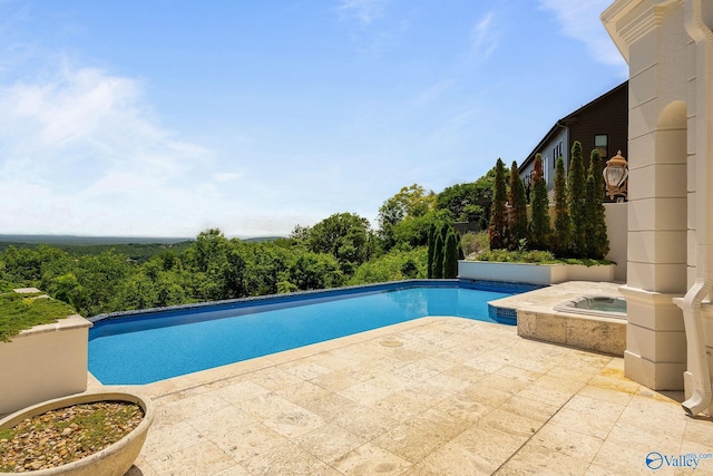 view of pool featuring an in ground hot tub and a patio area