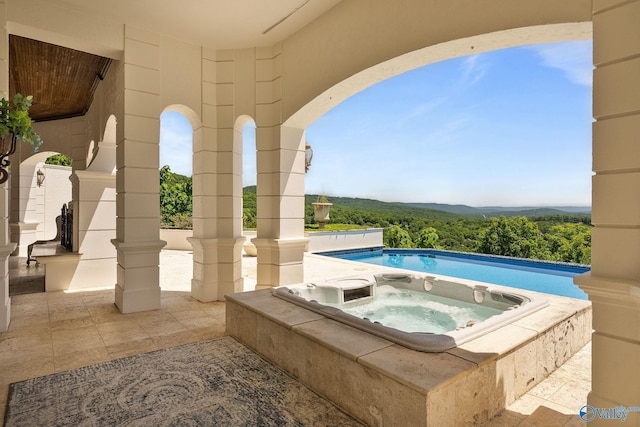 view of swimming pool with an in ground hot tub and a patio