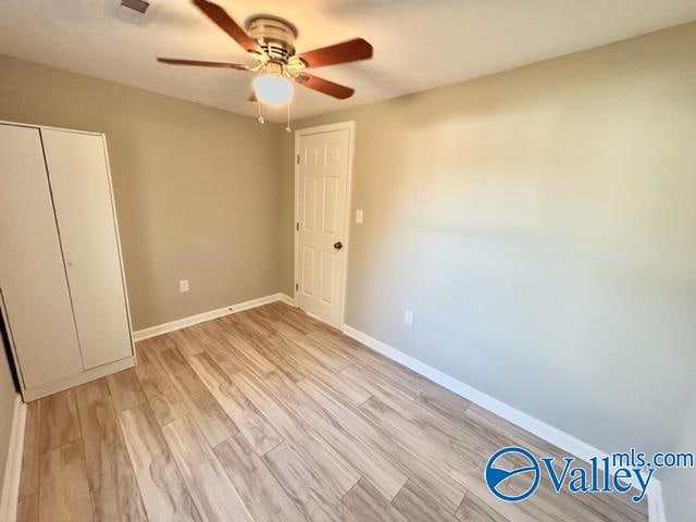 unfurnished bedroom with light hardwood / wood-style flooring and ceiling fan