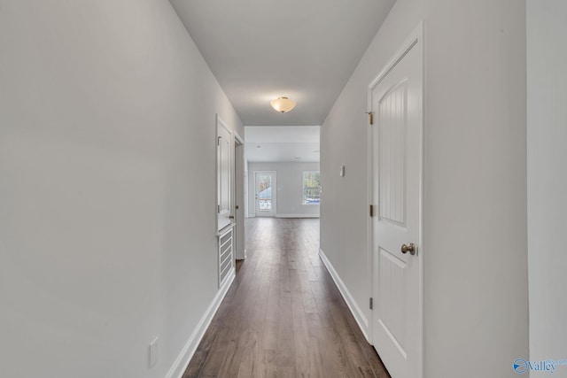 hallway with baseboards and dark wood finished floors