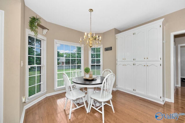 dining room with an inviting chandelier and light hardwood / wood-style flooring