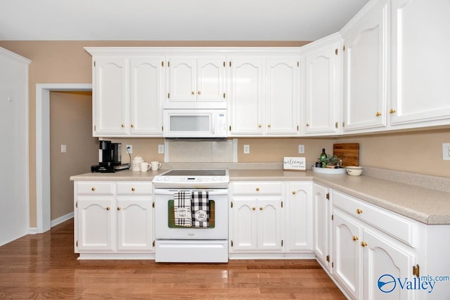 kitchen with white cabinets, white appliances, and light hardwood / wood-style floors