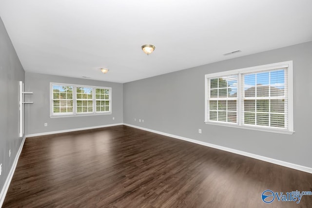 spare room with dark hardwood / wood-style flooring