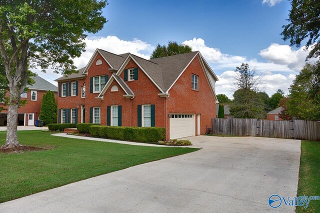 view of front of home with a garage and a front lawn