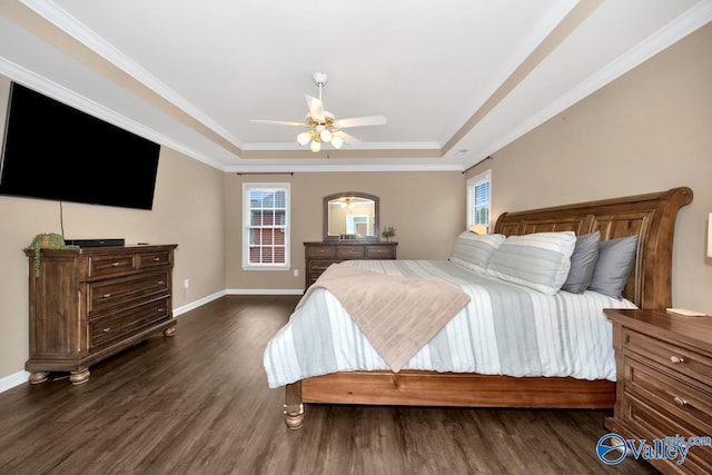 bedroom featuring dark hardwood / wood-style floors, ceiling fan, a tray ceiling, and crown molding