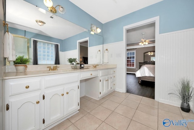 bathroom with tile patterned flooring, vanity, and ceiling fan