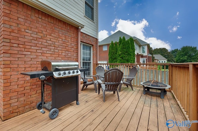 deck featuring area for grilling and an outdoor fire pit