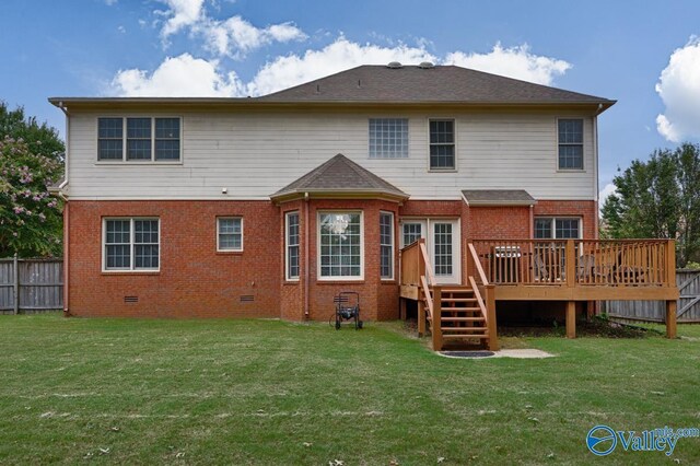 rear view of property with a deck and a lawn