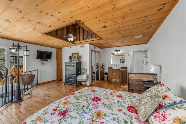 bedroom with wood ceiling, ornamental molding, and light hardwood / wood-style flooring