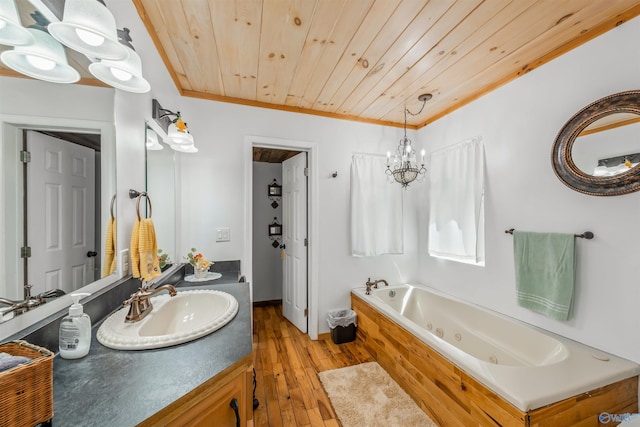 bathroom with a washtub, crown molding, hardwood / wood-style flooring, vanity, and wooden ceiling