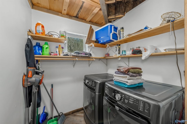 clothes washing area with wood-type flooring, washing machine and clothes dryer, and wood ceiling