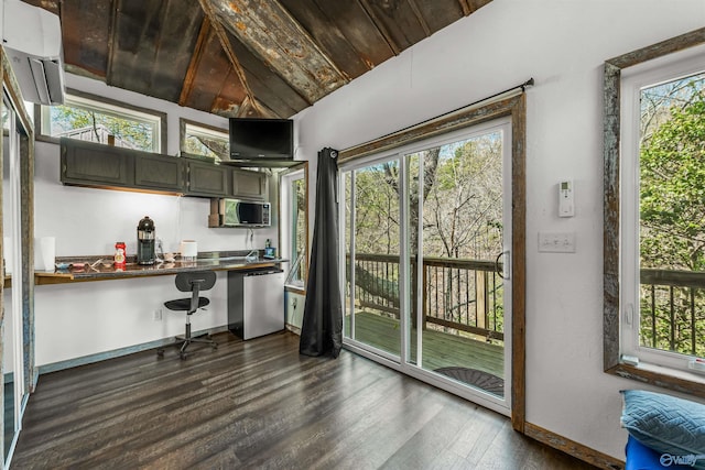 kitchen featuring built in desk, dark hardwood / wood-style floors, dishwasher, and vaulted ceiling