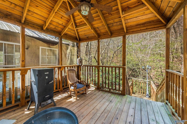 wooden terrace with a gazebo and ceiling fan