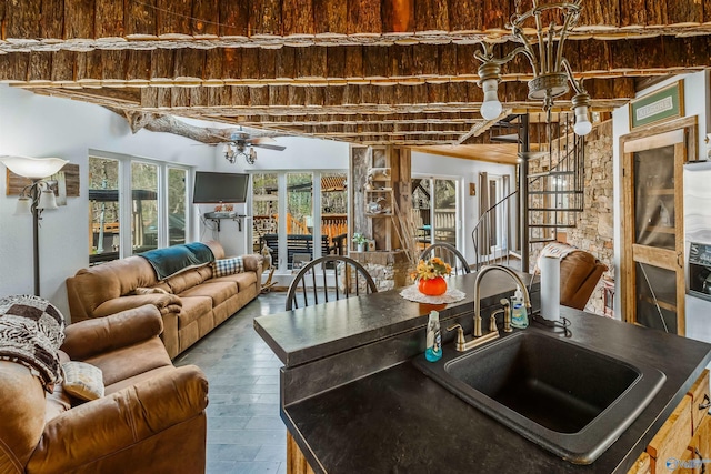 kitchen with ceiling fan, wood-type flooring, and sink