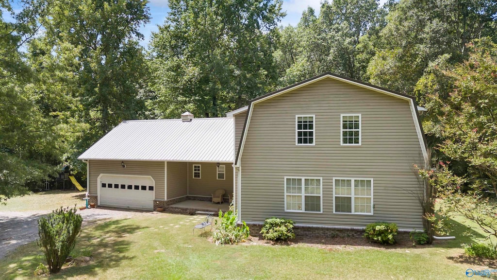 view of front of property with a garage and a front lawn