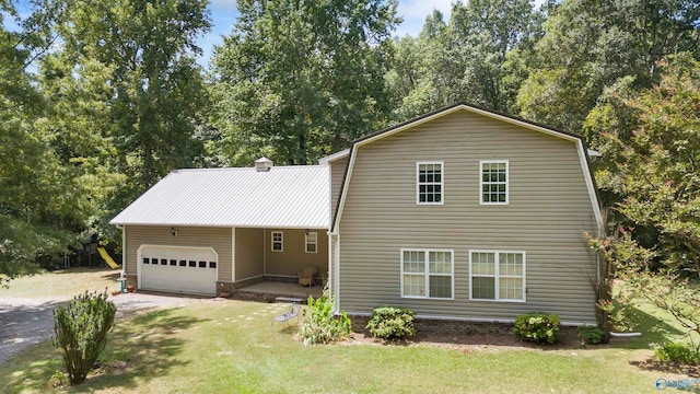 view of front of property with a garage and a front lawn