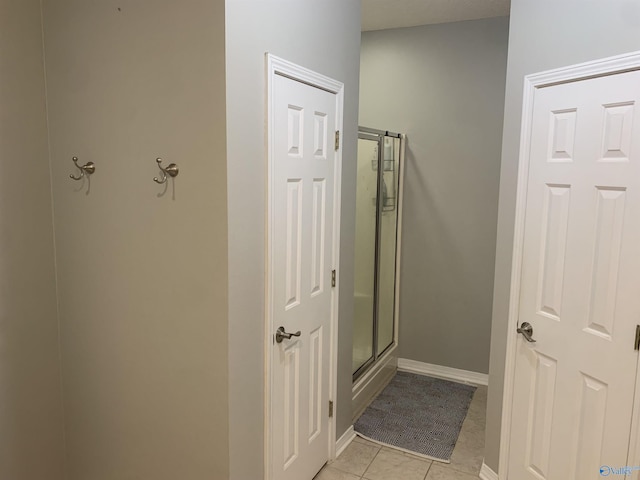 bathroom featuring tile patterned flooring and a shower with shower door