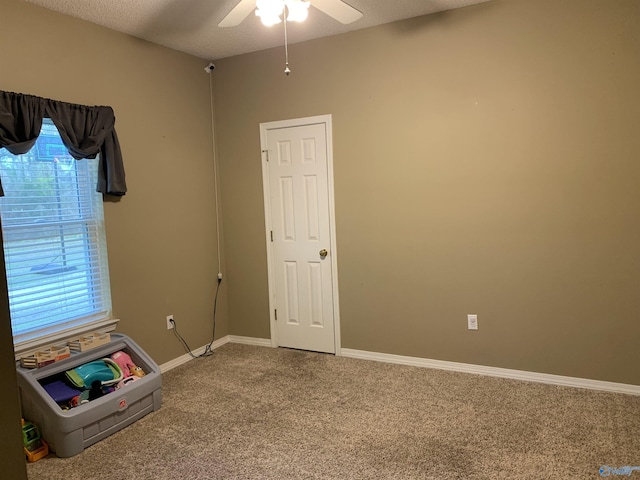 interior space with a textured ceiling and ceiling fan