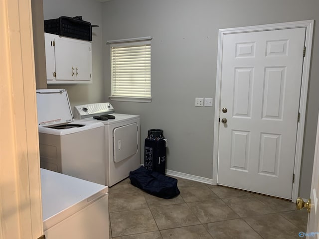 washroom with cabinets, light tile patterned floors, and washer and dryer