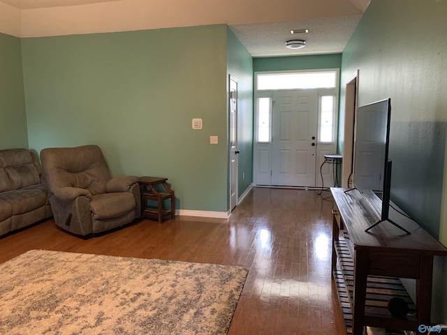 foyer entrance featuring hardwood / wood-style flooring and a textured ceiling