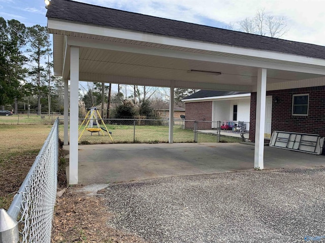 view of vehicle parking with a carport and a yard